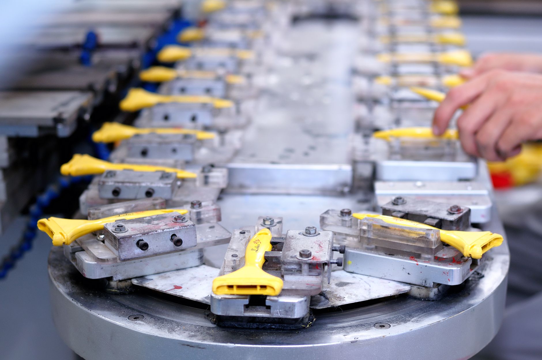 Components moving through an assembly line, representing parent-child genealogy tracking in manufacturing