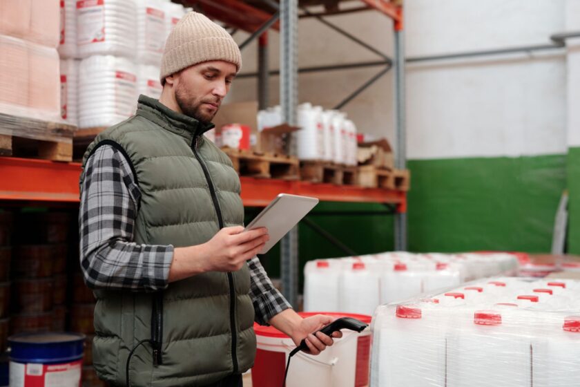 Worker scanning a barcode on a production line to record traceability data
