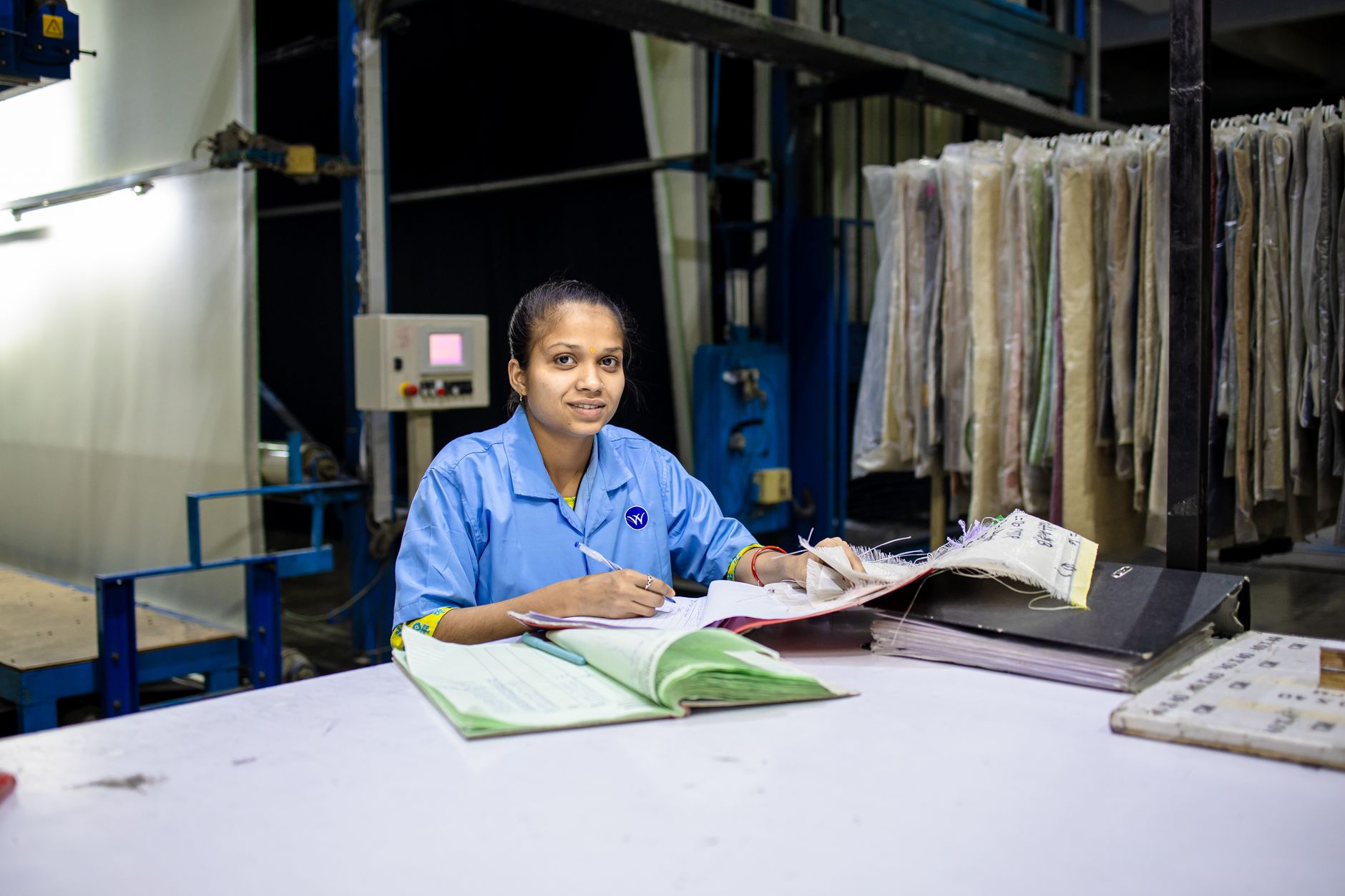 A manufacturing engineer reviewing a digital work instruction on a tablet on the shop floor