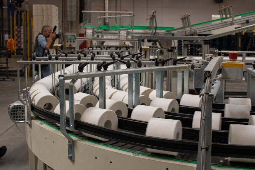 Machine vision camera mounted above a conveyor line inspecting parts in a manufacturing plant