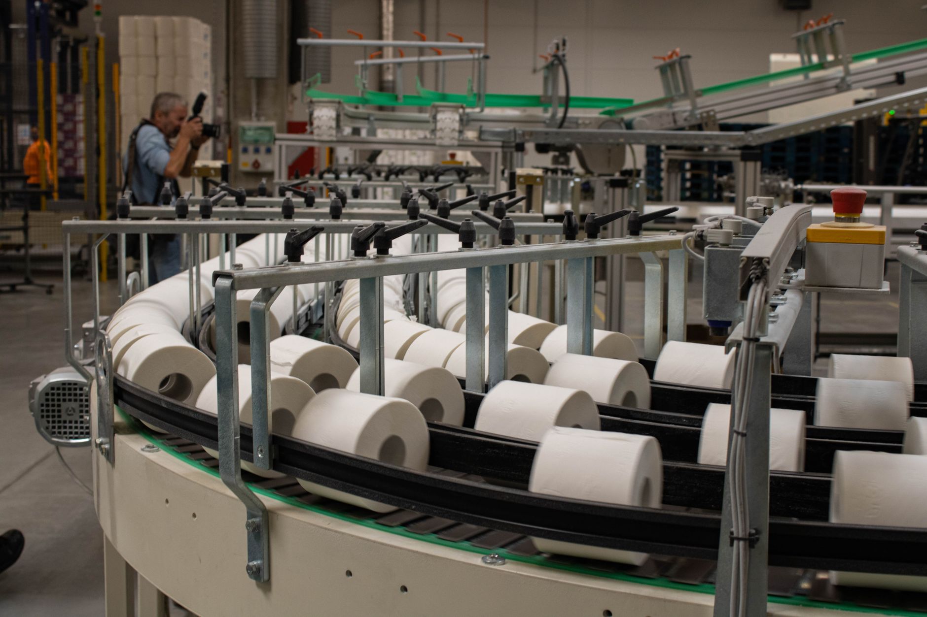 Machine vision camera mounted above a conveyor line inspecting parts in a manufacturing plant