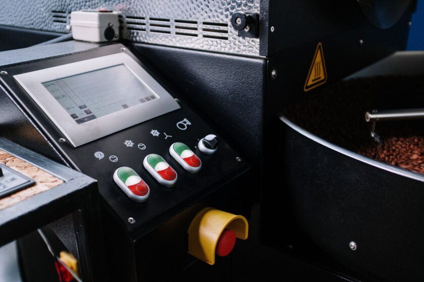 An HMI screen on a factory floor displaying machine state and mode information