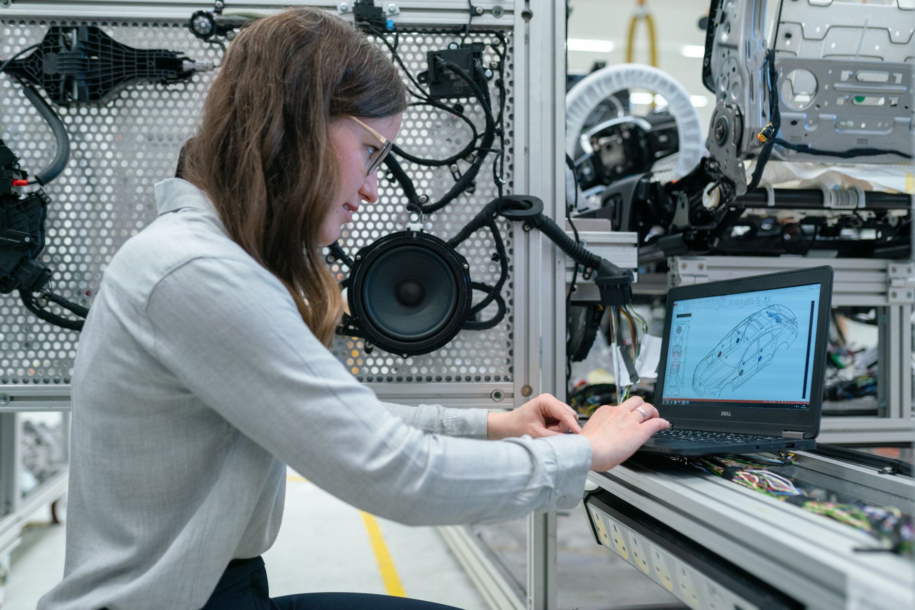 Automation engineer working at a workstation with PLC programming software on screen