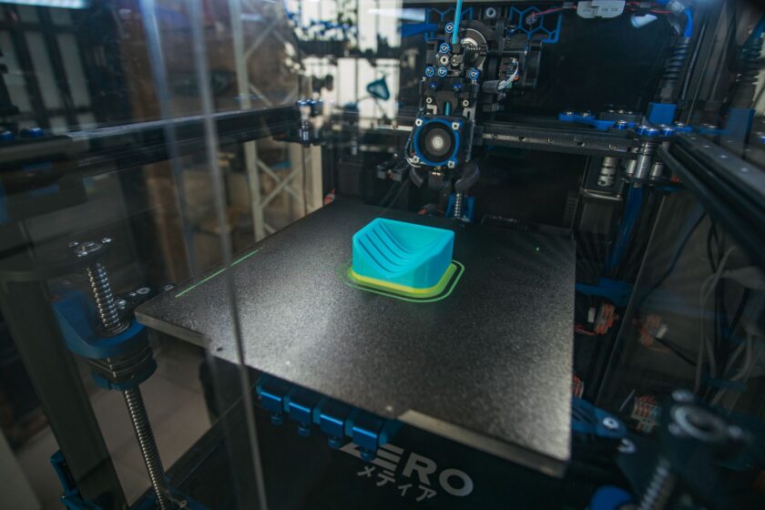 Industrial metal additive manufacturing machine on a factory floor connected to shop floor systems
