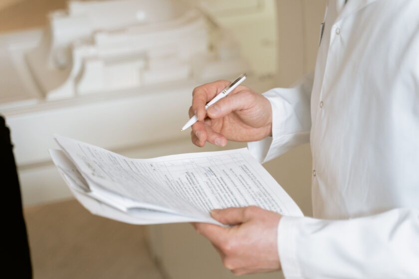 Quality reviewer examining an electronic batch record on a screen in a manufacturing plant