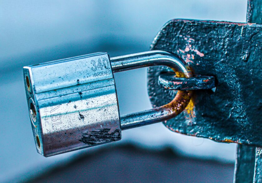 Digital padlock icon overlaid on an industrial control cabinet representing OPC UA certificate security