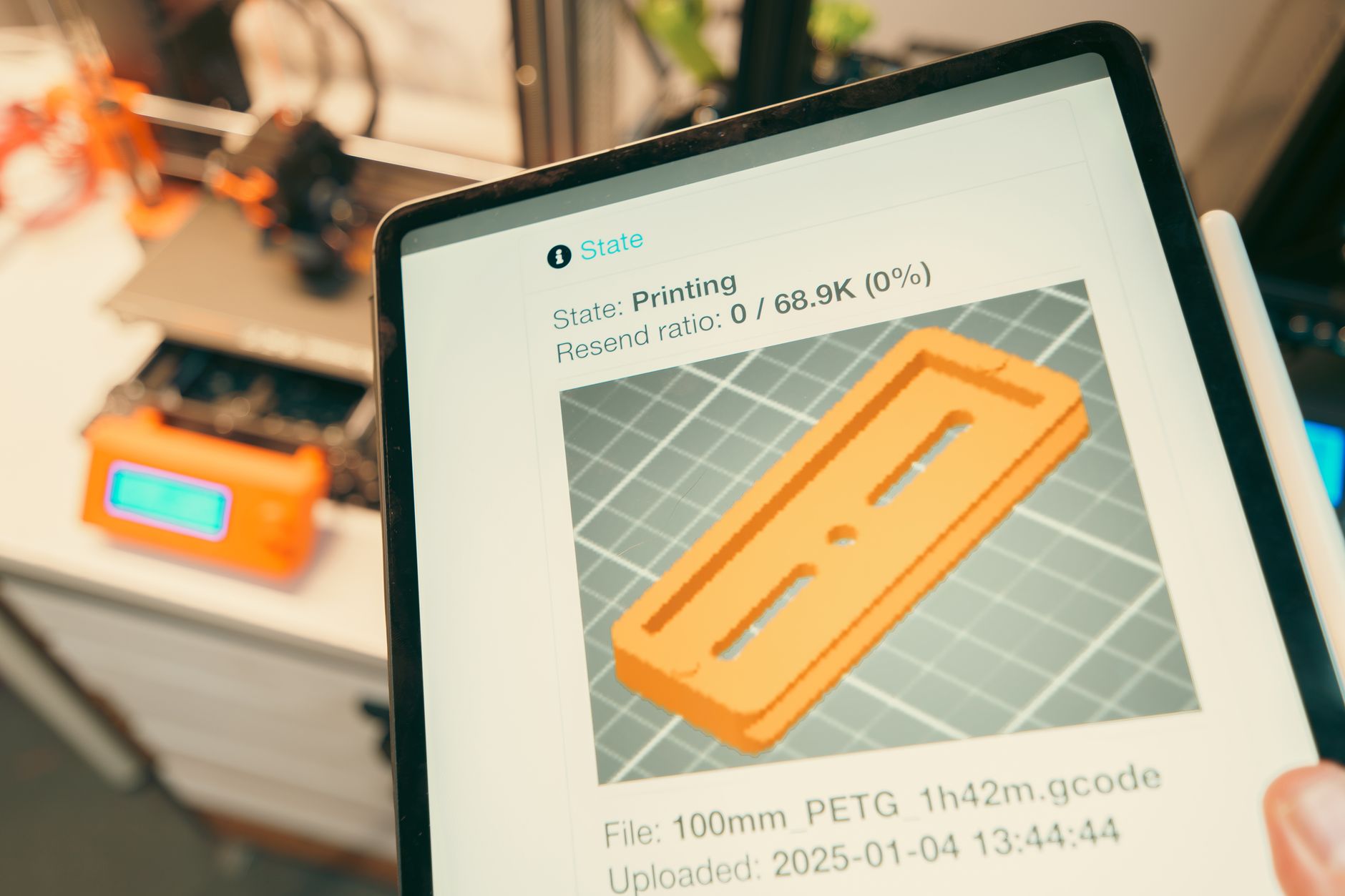 A manufacturing engineer building a shop-floor app on a tablet next to production equipment