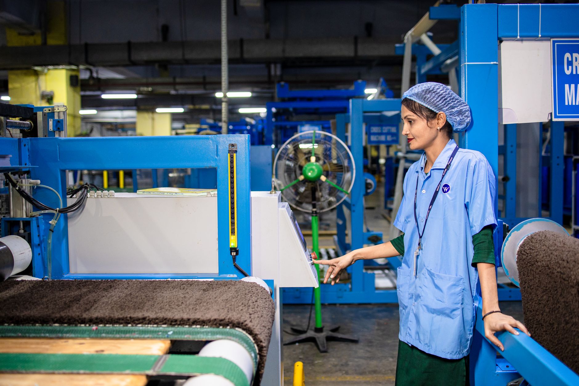 Factory operator using a tablet-based app on the production line, representing a low-code MES interface