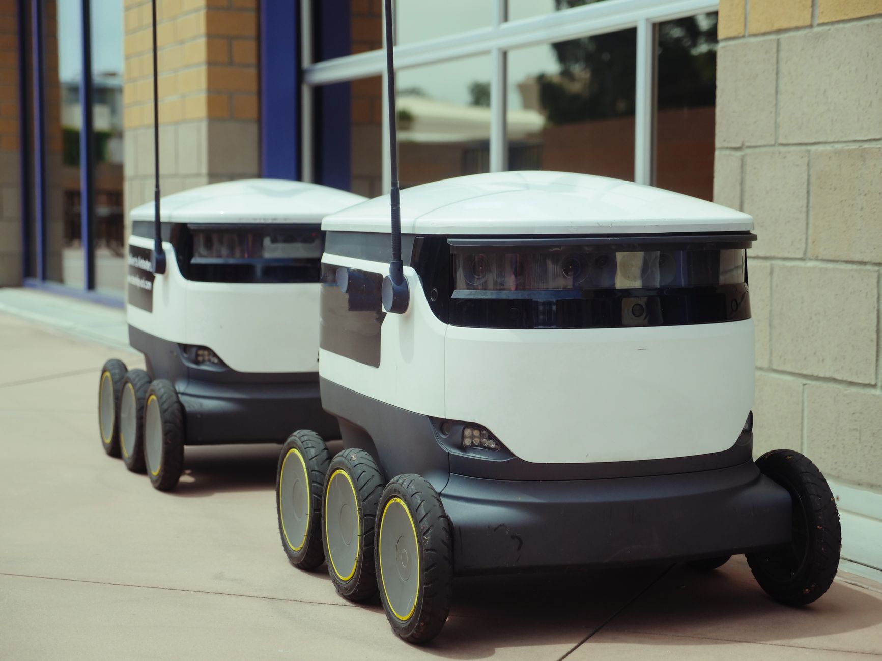 Multiple autonomous mobile robots moving materials on a factory floor under fleet control