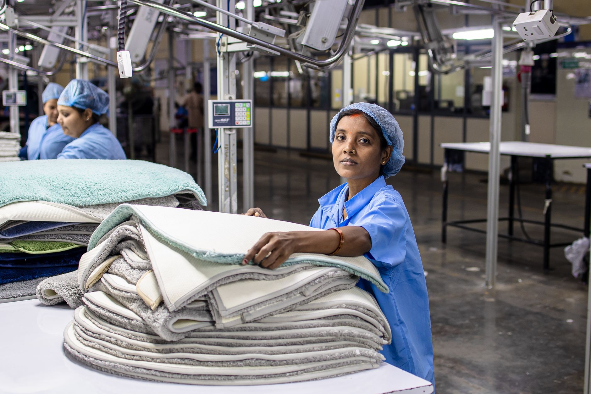Workers at stations along a manufacturing assembly line, illustrating takt time and cycle time concepts