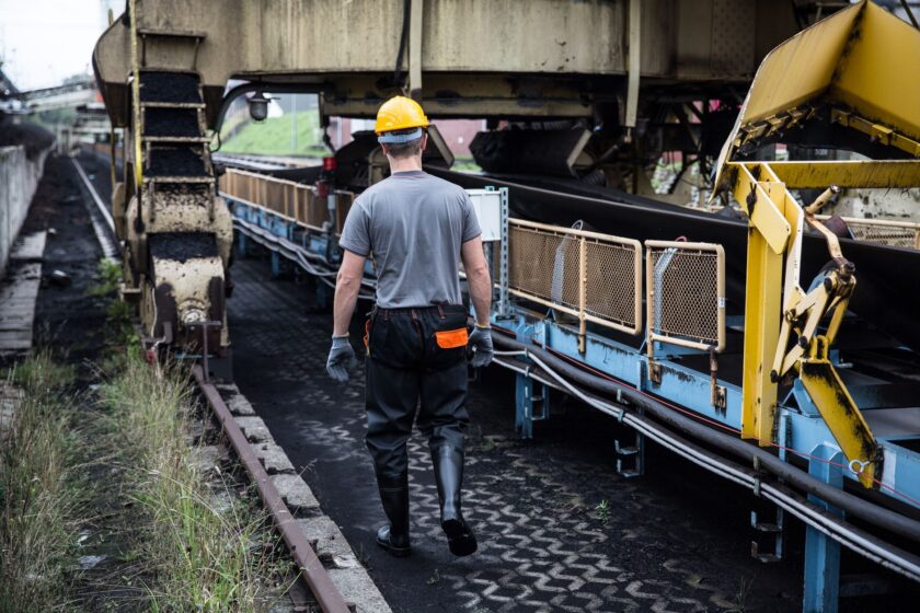 Work-in-process parts queued in a buffer zone between automated production stations