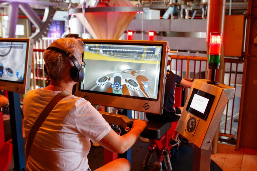 Engineer viewing a simulated factory floor rendered as a digital twin on a monitor