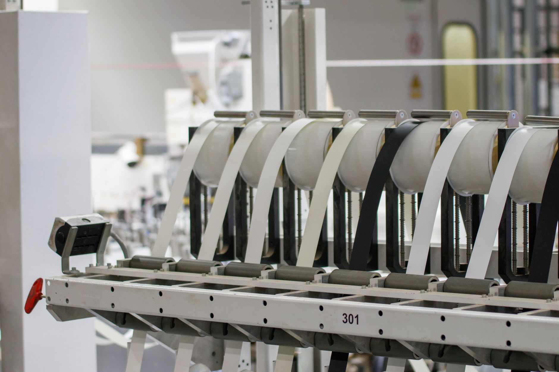 Operator adjusting machine tooling during a production changeover on a factory floor