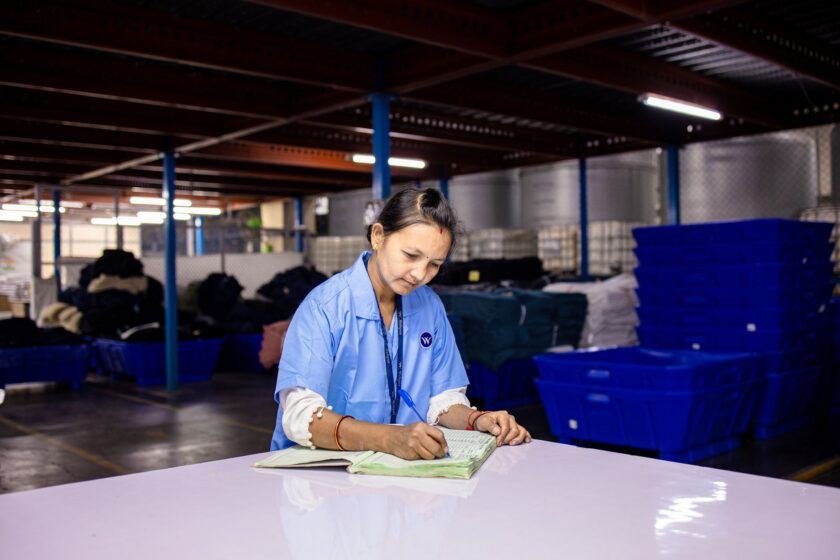 Manufacturing engineer reviewing production genealogy and traceability records on a screen in a plant