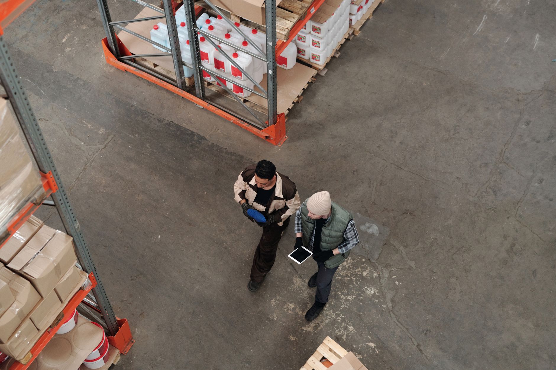 Operator using a tablet-based digital workflow app on a manufacturing shop floor