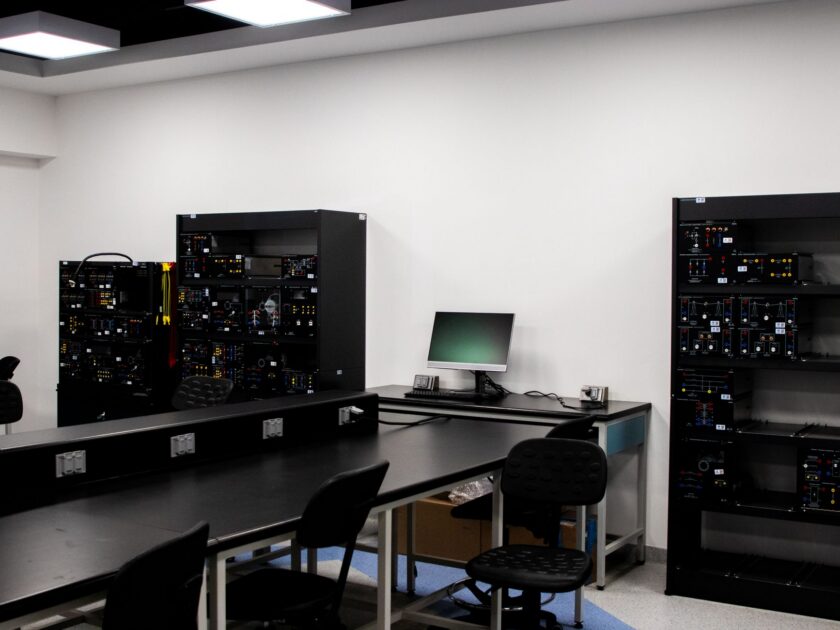 Engineer reviewing manufacturing software dashboards in an industrial control room