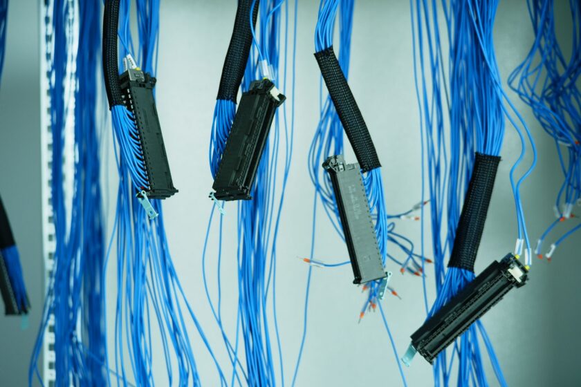Close-up of industrial Ethernet cabling and terminal blocks inside an automation control cabinet