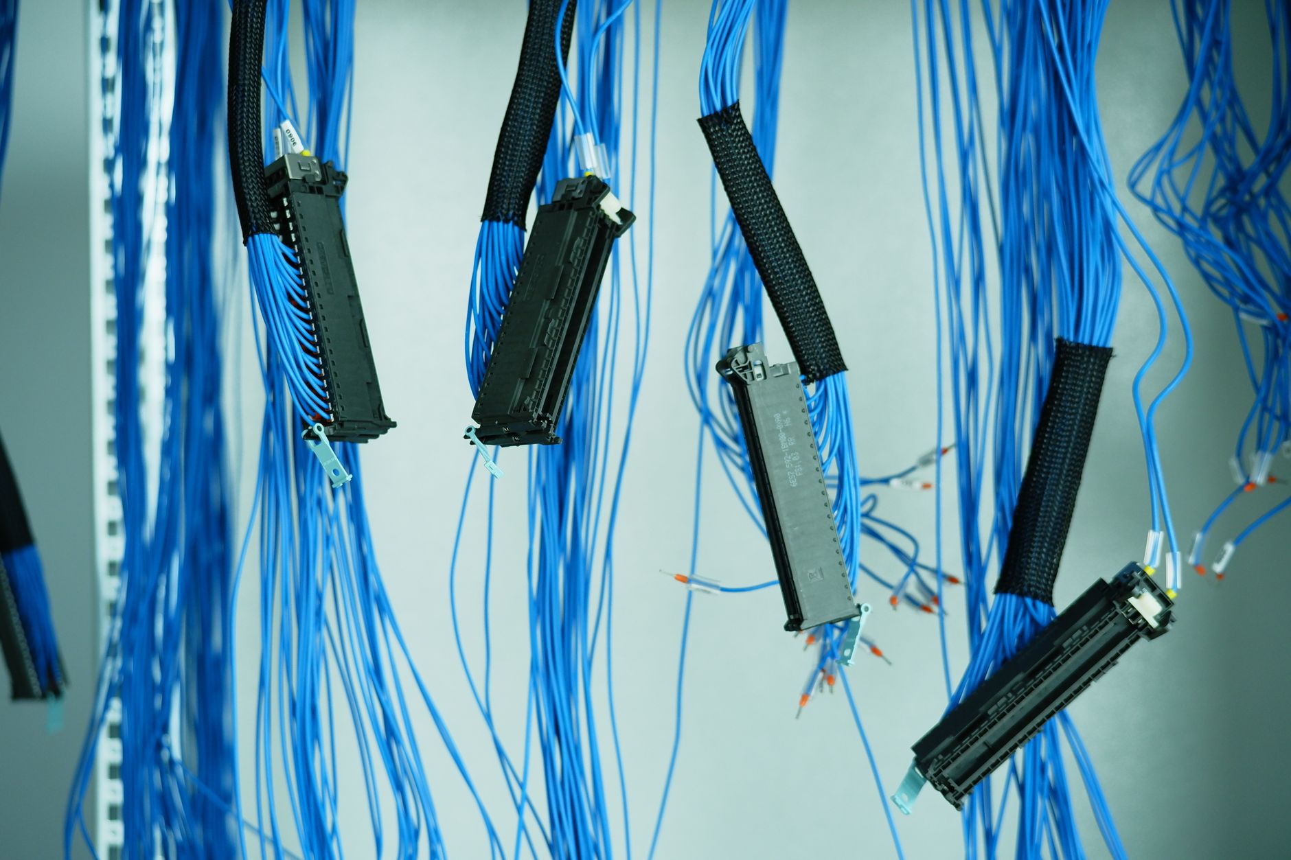 Close-up of industrial Ethernet cabling and terminal blocks inside an automation control cabinet