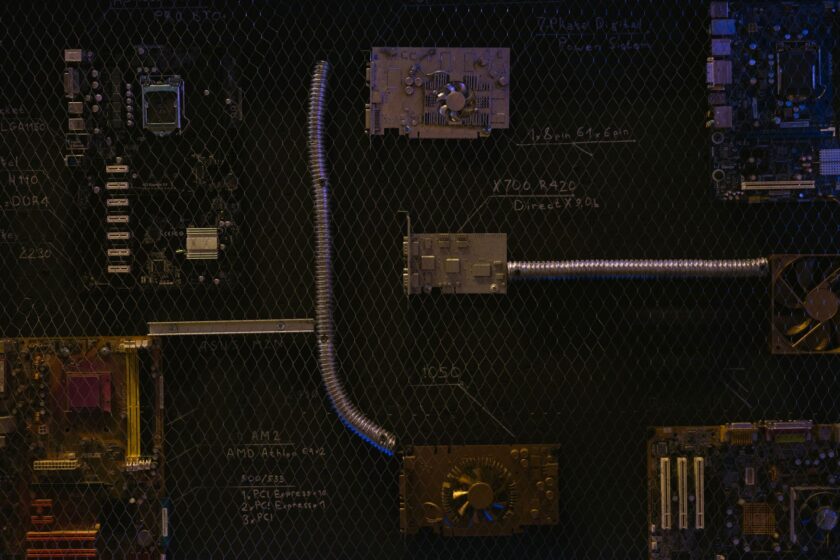 Engineer reviewing an industrial network segmentation diagram on a laptop near plant floor equipment