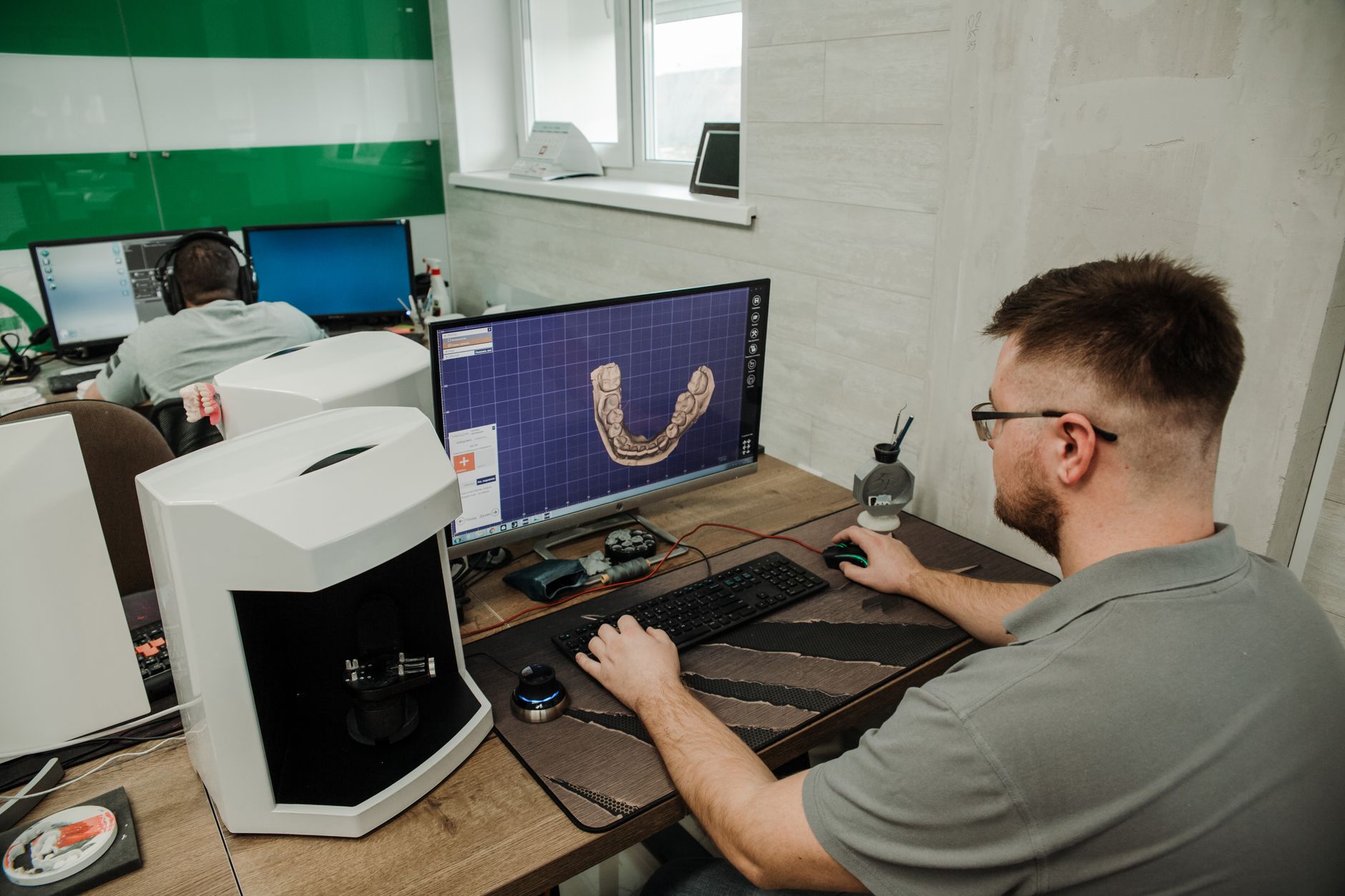 A technician comparing a CAD drawing to a machine setup during a changeover