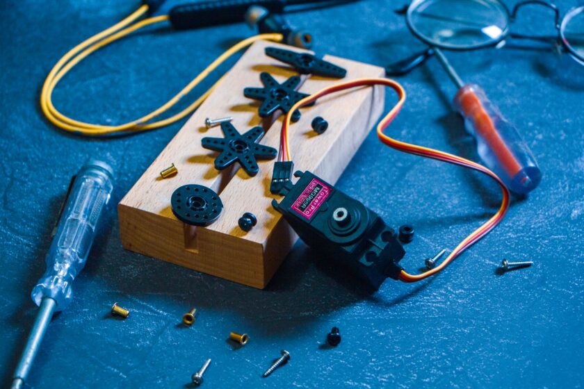 Industrial servo drive and motion controller with diagnostic displays on a factory floor